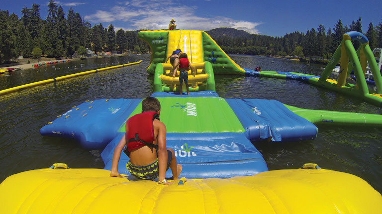 Kids playing on inflatable course